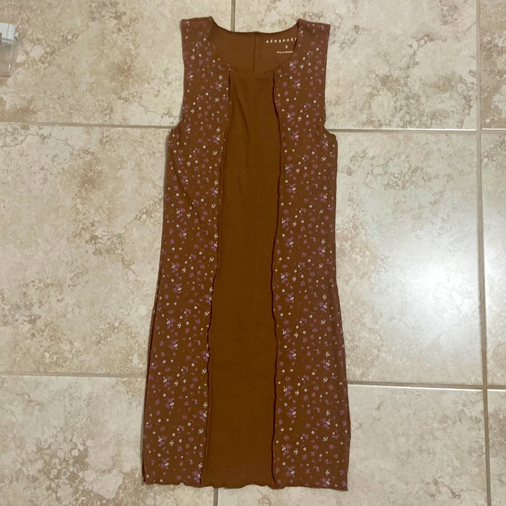 A brown dress with floral designs.